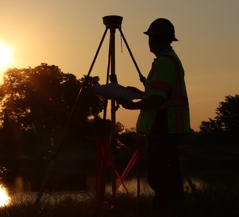 Employee using survey equipment