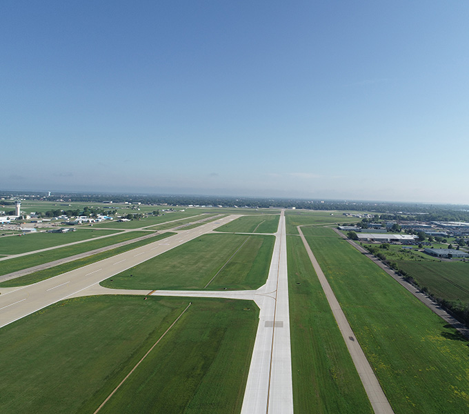 Aerial image of a long airport taxiway.