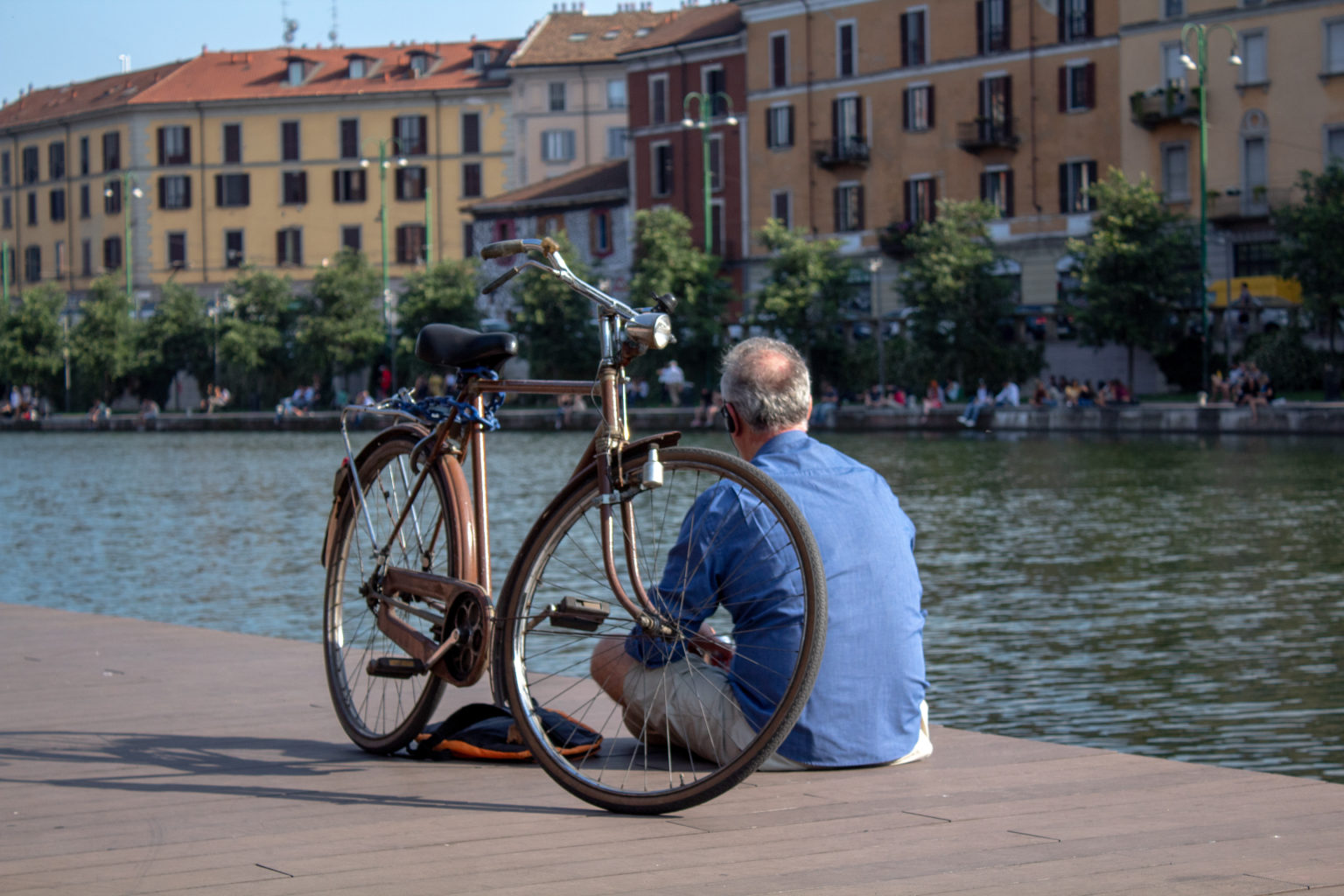 male biker and bicycle sitting by water