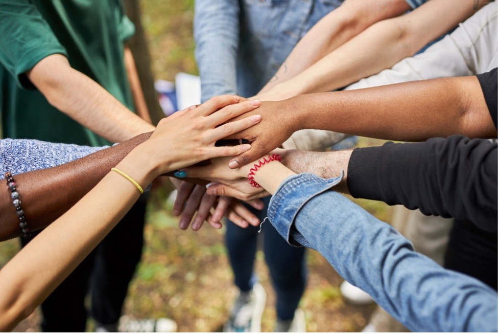 All hands in the middle of a pile