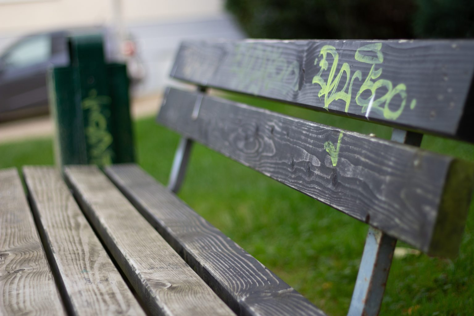 Bench with yellow graffiti 