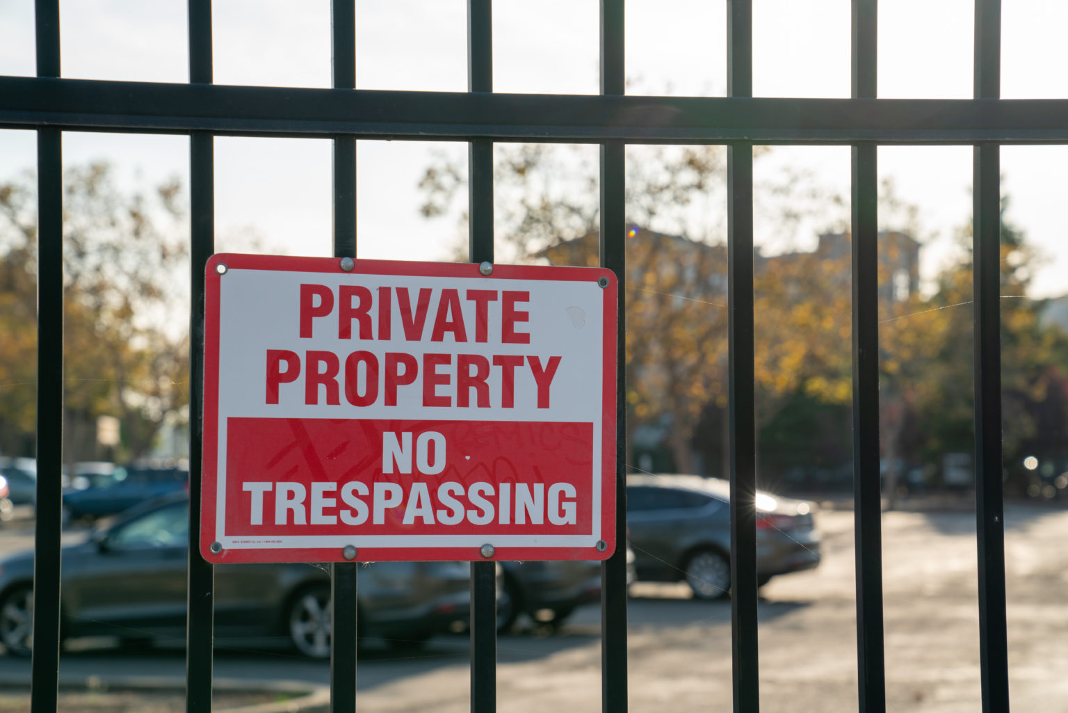 Private Property No Trespassing red sign on a fence