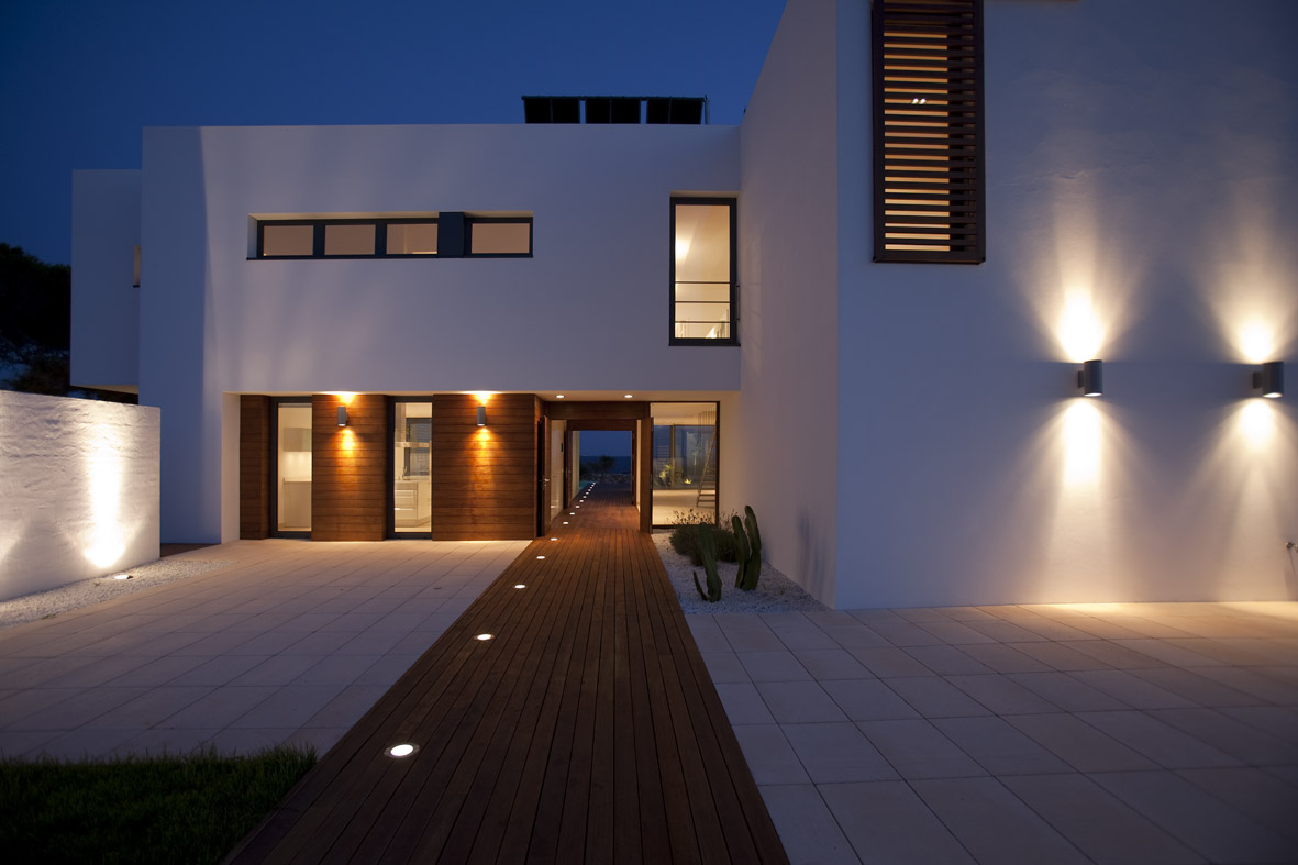 White home at night light up with outdoor lighting